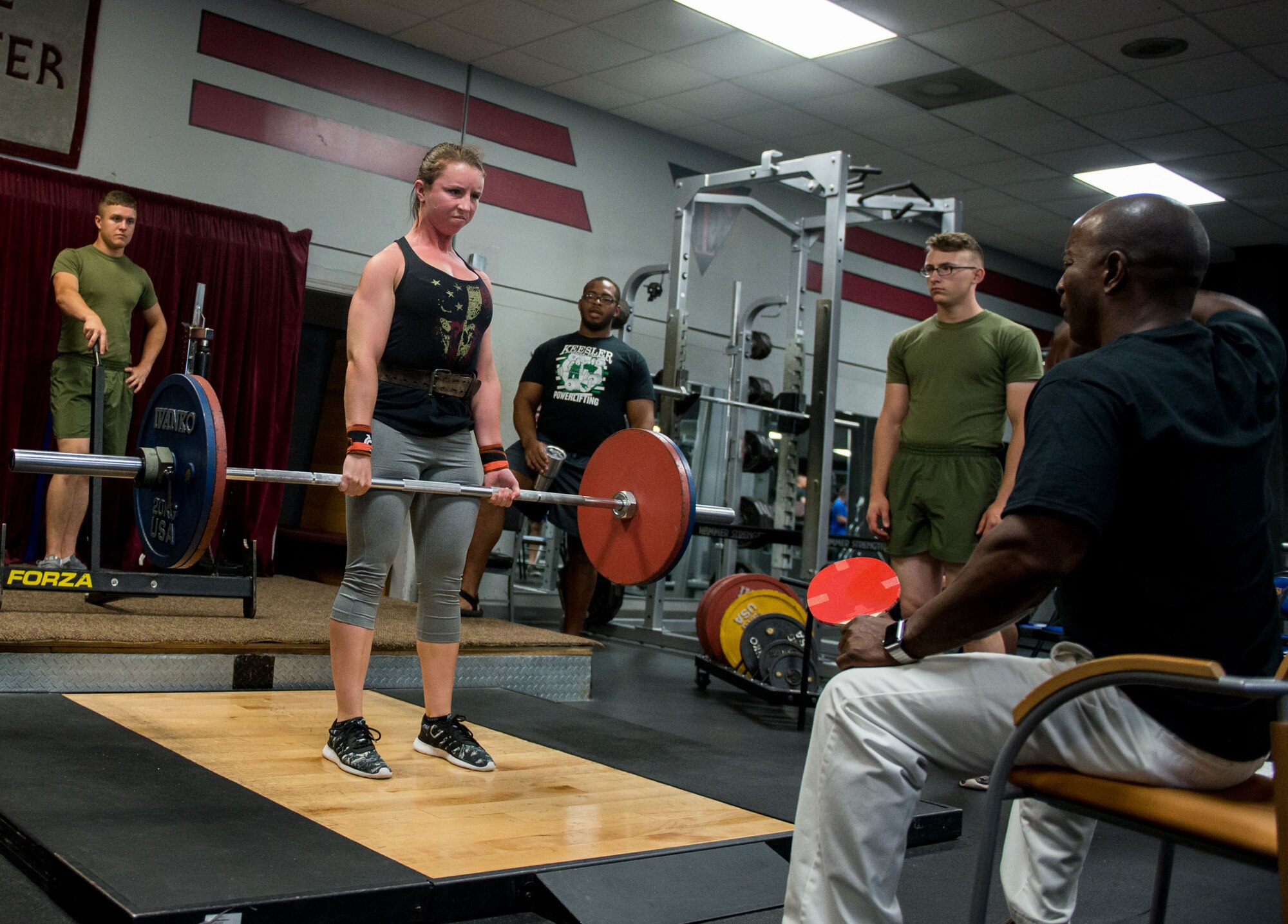 U.S. Marine Lance Cpl. Delaney Grimes, 335th Training Squadron student, competes in the dead lift portion of the annual Muscle Mania event at the Triangle Fitness Center July 16, 2016, on Keesler Air Force Base, Miss. The powerlifting event was open to men and women and featured squat, deadlift and bench press categories. Grimes placed first overall in the women’s division. (U.S. Air Force photo by Marie Floyd/Released)