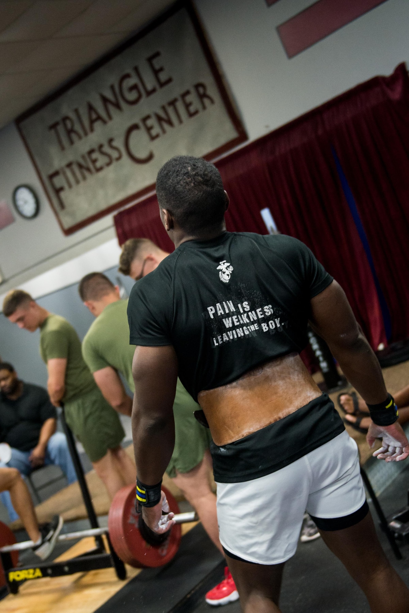 U.S. Marine Sgt. Azariah Pierce, Marine Corps Recruiting Sub-Station Baton Rouge North detachment recruiter, prepares to compete in the annual Muscle Mania event at the Triangle Fitness Center July 16, 2016, on Keesler Air Force Base, Miss. The powerlifting event was open to men and women and featured squat, deadlift and bench press categories. Pierce placed first overall in the men’s division. (U.S. Air Force photo by Marie Floyd/Released) 