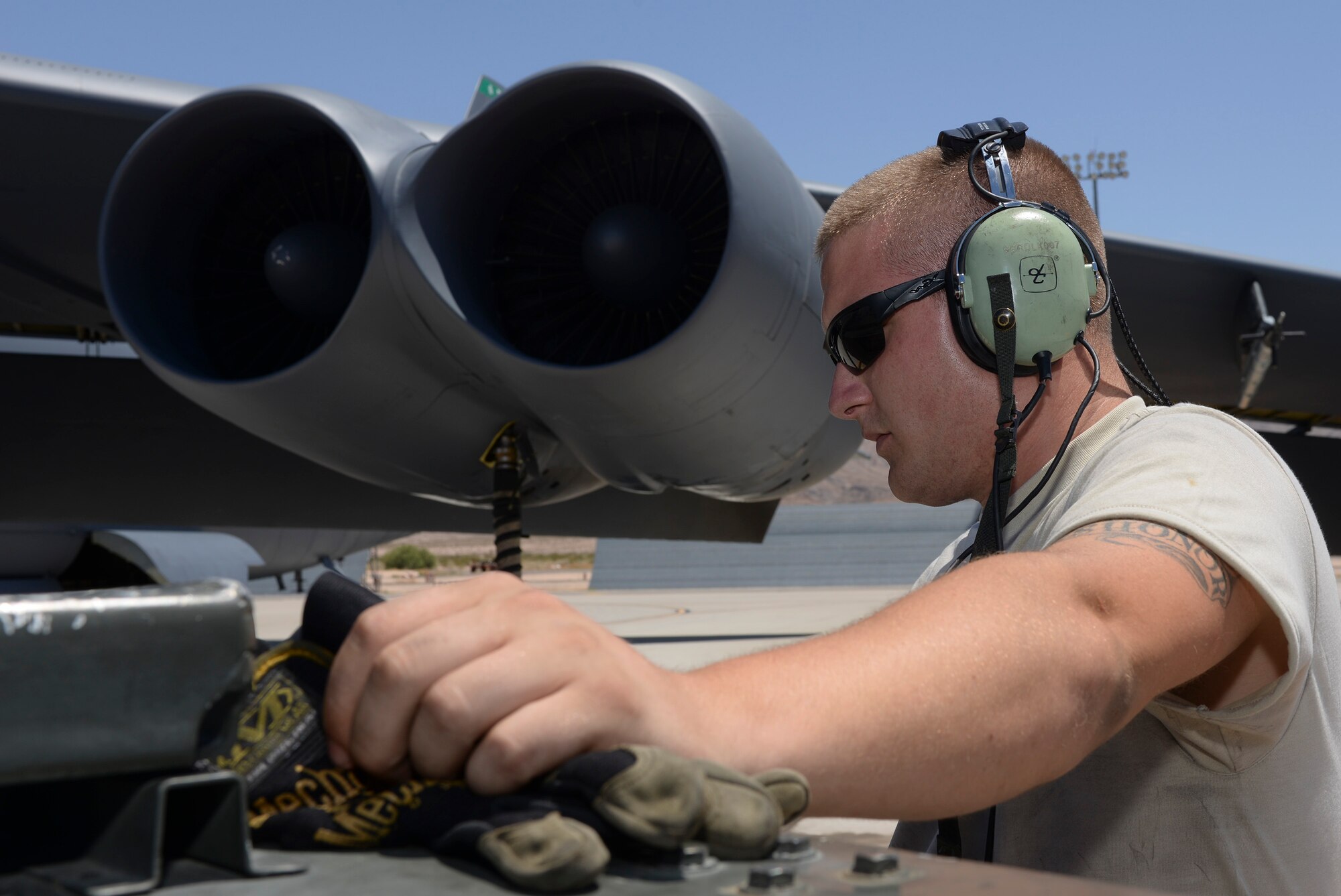 Senior Airman Elias Sapp, 96th Bomb Squadron crew chief, prepares a B-52 Stratofortress for takeoff during Red Flag 16-3 at Nellis Air Force Base, Nev., July 18, 2016. Red Flag provides an opportunity for the 96th BS aircrew and maintainers the ability to hone their tactical skillsets in a challenging environment. (U.S. Air Force photo by Senior Airman Kristin High/Released)