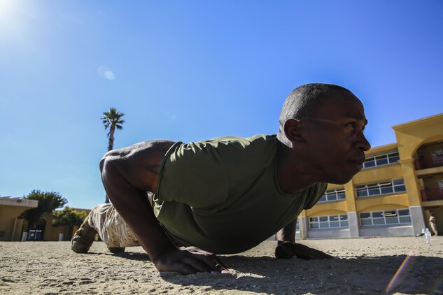 Private First Class Shawndel Hunter, Delta Company, 1st Recruit Training Battalion, does a pushup at  Marine Corps Recruit Depot San Diego, July 18.  Following recruit training, he will report to the School of Infantry at Marine Corps Base Camp Pendleton, Calif., and then move on to his military occupational specialty school to learn his job as an aviation electronics technician where he hopes to one day become a warrant officer. Hunter also plans on trying out for the Marine Corps mixed martial arts team and serving in the Corps for as long as he can. 

