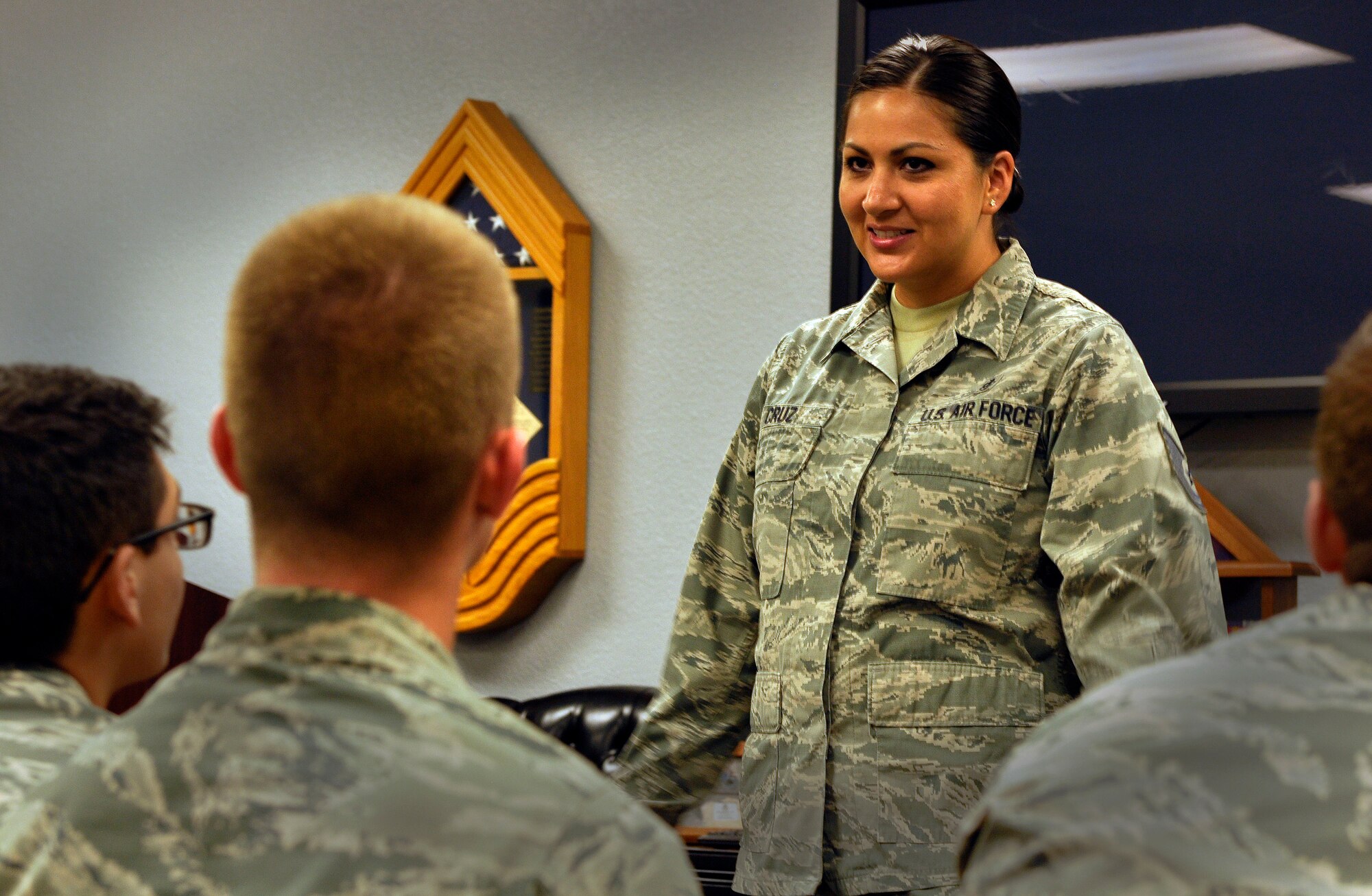 Tech. Sgt. Cassandra Cruz, 81st Force Support Squadron Airman Leadership School instructor instructs a group of students at the ALS building, July 21, 2016, on Keesler Air Force Base, Miss. Cruz was selected as one of this year’s 12 Outstanding Airmen of the Year. Volunteers assisted in providing staged photos of Cruz on the job for display in the Pentagon. (U.S. Air Force photo by Tech. Sgt. Kimberly Rae Moore/Released)