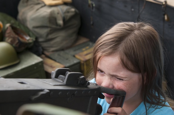 Rachel Carnley, 7,  daughter of 1st Lt. Raun Carnley, 320th Missile Squadron missile combat crew commander, looks down the sights of a World War II-era machine gun on display July 22, 2016, at Fort D.A. Russell Days, the annual F.E. Warren Air Force base, Wyo., open house. American military history from the American Revolution to today is displayed at the open house. (U.S. Air Force photo by Senior Airman Jason Wiese)