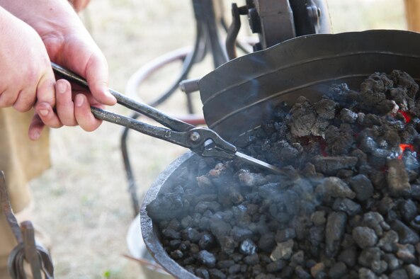 Retired Staff Sgt. Andrew Nofzinger heats up a piece of iron July 22, 2016, during Fort D.A. Russell Days, the annual F.E. Warren Air Force Base, Wyo., open house. Blacksmithing was a vital survival skill for settlers of the American frontier. (U.S. Air Force photo by Senior Airman Jason Wiese)