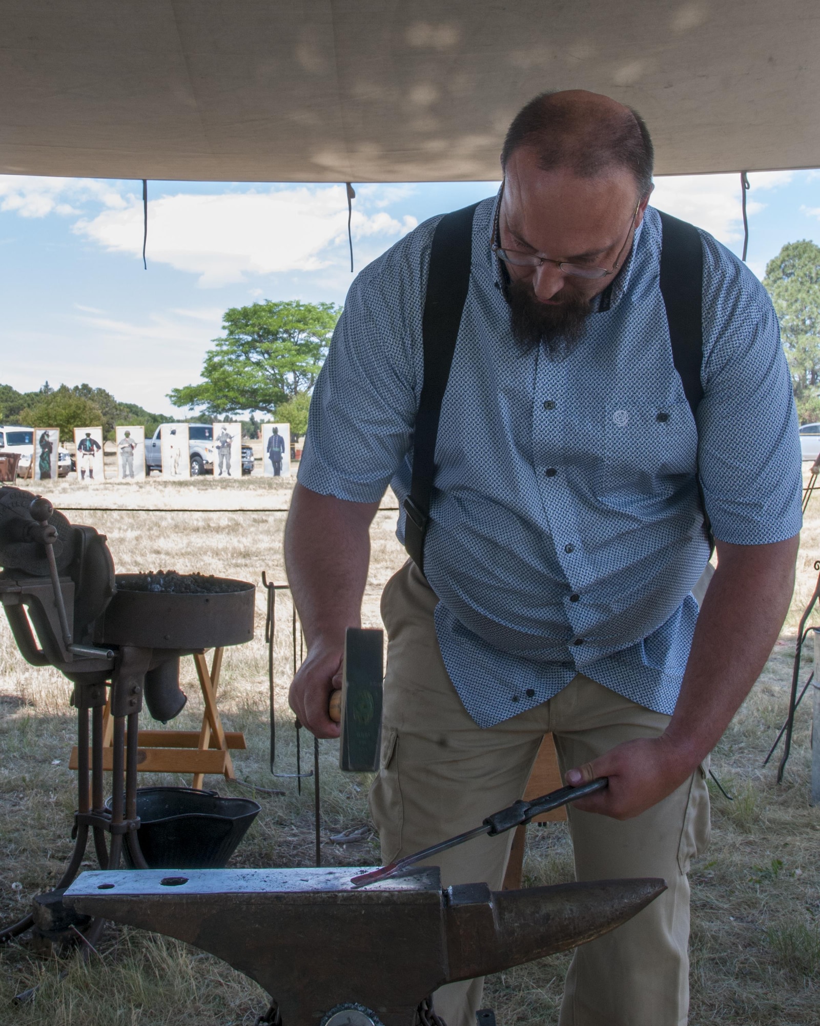 Retired Staff Sgt. Andrew Nofzinger hammers a new decorative hook July 22, 2016, during Fort D.A. Russell Days, the annual F.E. Warren Air Force Base, Wyo., open house. Blacksmithing was a vital survival skill for settlers of the American frontier. (U.S. Air Force photo by Senior Airman Jason Wiese)
