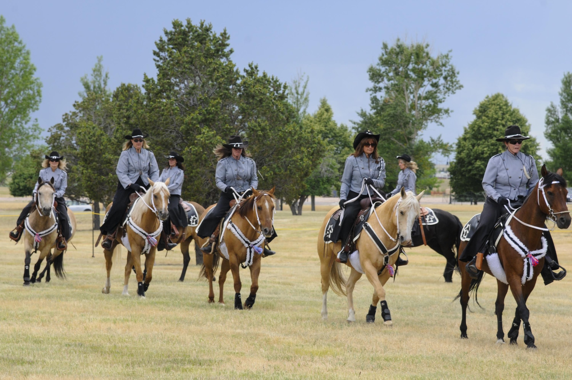 Members of the Trotters turn a corner in a column as they demonstrate their horse-riding skills July 22, 2016, during Fort D.A. Russell Days, the annual F.E. Warren Air Force Base, Wyo., open house. The Trotters perform at the open house each year. (U.S. Air Force photo by Senior Airman Jason Wiese)