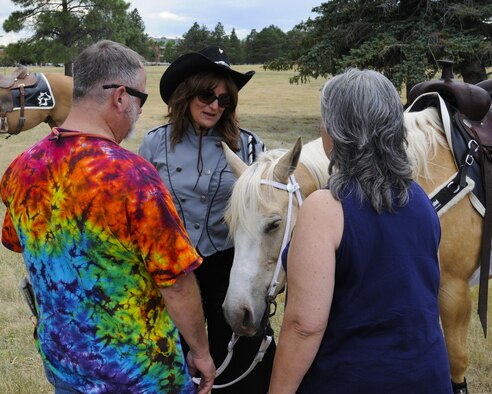 Spectators get a chance to meet one of the Trotters' horses, Cricket, and her rider, Holli Guillori, after viewing the group's riding performance July 22, 2016, during Fort D.A. Russell Days, the annual F.E. Warren Air Force Base, Wyo., open house. Each horse is well trained to bear their rider in formation. (U.S. Air Force photo by Senior Airman Jason Wiese)
