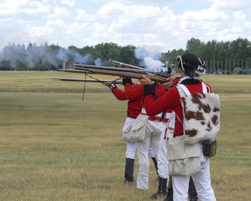 Re-enactors fire a volley of blank rounds while performing a mock American Revolution battle July 22, 2016, during Fort D.A. Russell Days, the annual F.E. Warren Air Force Base, Wyo., open house. The re-enactor group, Vision Heirs, arrives each year to the open house to put on the living history demonstration. (U.S. Air Force photo by Senior Airman Jason Wiese)