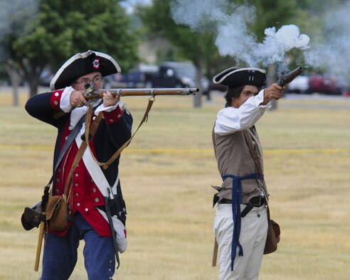 Re-enactors fire a volley of blank rounds while performing a mock American Revolution battle July 22, 2016, during Fort D.A. Russell Days, the annual F.E. Warren Air Force Base, Wyo., open house. The re-enactor group, Vision Heirs, arrives each year to the open house to put on the living history demonstration. (U.S. Air Force photo by Senior Airman Jason Wiese)