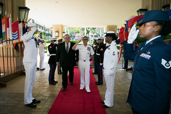 (July 22, 2016) - CAMP H.M. SMITH, Hawaii (July 22, 2016) - Commander of U.S. Pacific Command (USPACOM), Adm. Harry B. Harris Jr., right, and New Zealand Minister of Defense, Gerry Brownlee, render honors during a welcome ceremony. Harris met with Brownlee at the USPACOM headquarters to discuss the security environment in the Indo-Asia-Pacific and planned ongoing activities in the USPACOM area of responsibility, including the United States Government's plan to conduct its first U.S. Navy ship visit to New Zealand in over three decades as part of the International Fleet Review associated with the Royal New Zealand Navy's 75th anniversary celebration in November 2016. (DoD photo by Chief Mass Communication Specialist Patrick Dille)