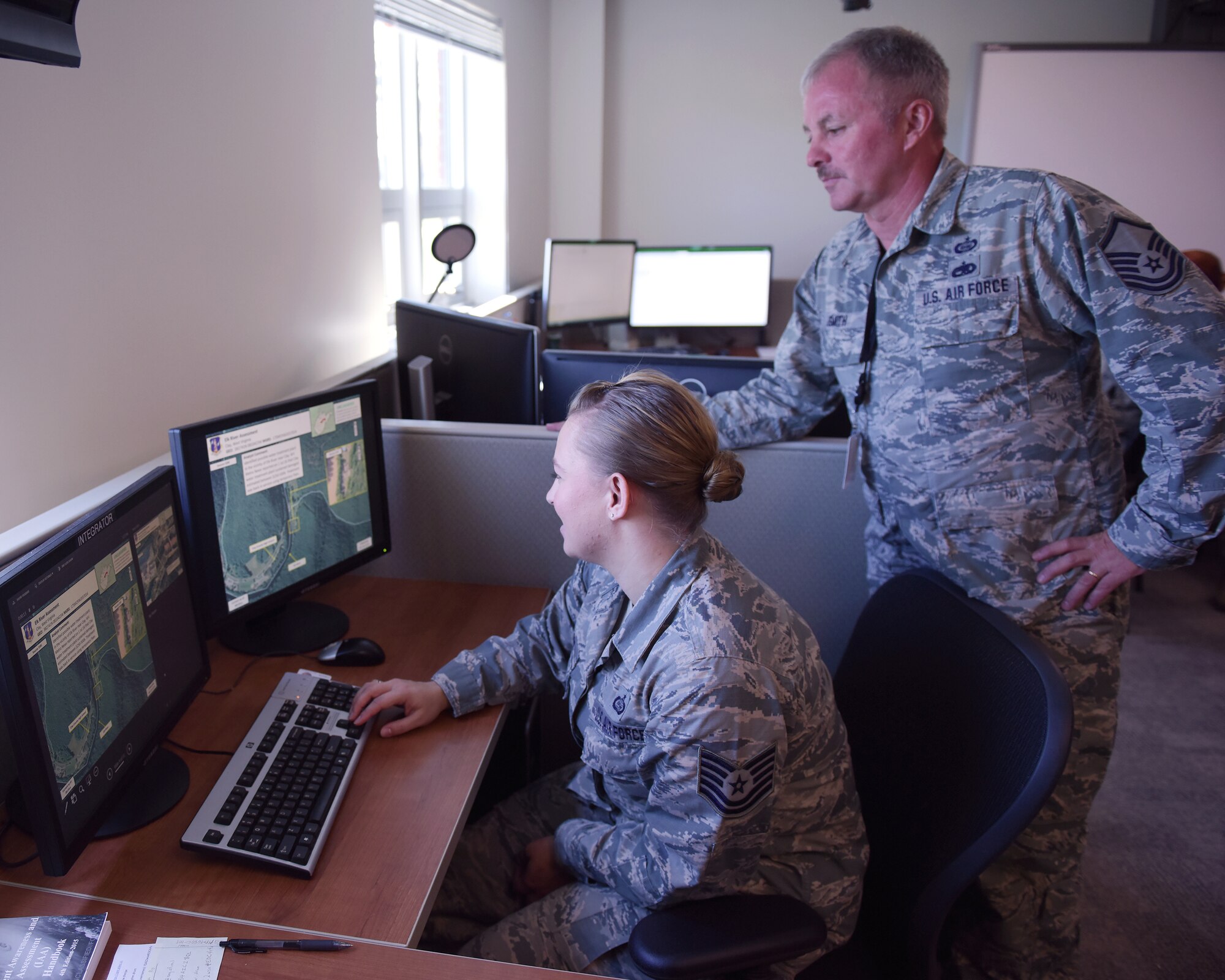 Ohio Air National Guard Tech Sgt. Erin Rogers, left, and Master Sgt. Glenn Smith, 178th Wing, prepare an Incident Awareness and Assessment product July 17, 2016, at Springfield Air National Guard Base, Springfield Ohio.  Rogers and Smith prepared the product in support of the recent flooding in West Virginia. (Ohio Air National Guard Photo by Master Sgt. Seth Skidmore)