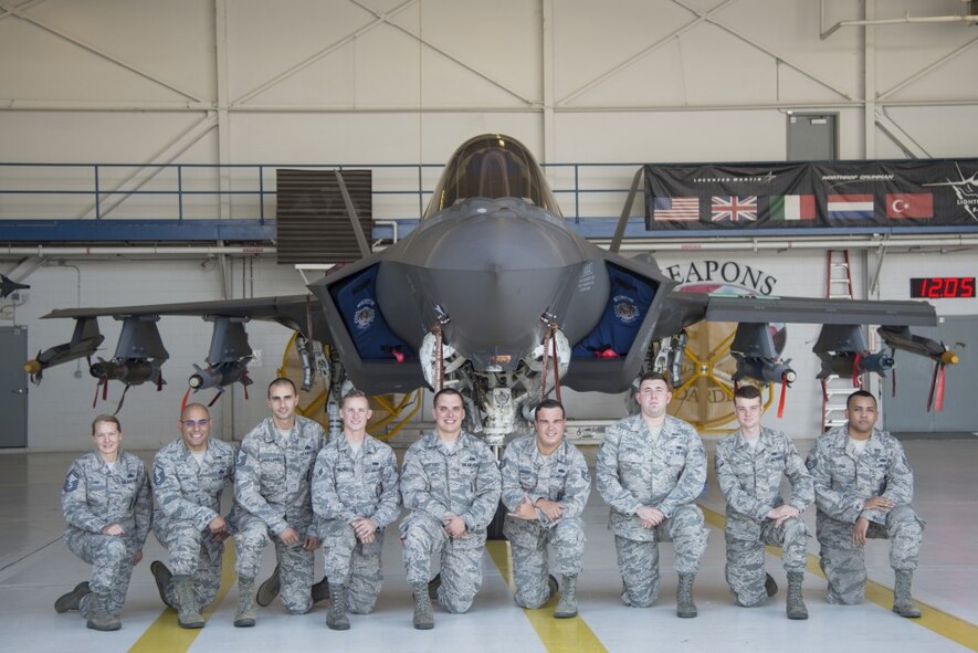 Airmen from the 33rd Aircraft Maintenance Squadron pose for a photo after loading an F-35 with two AIM-9X missiles, four GBU-12 bombs, a GBU-31 bomb, four Small Diameter Bombs, and two AIM-120 missiles July 20, 2016, at Eglin Air Force Base, Fla. This was the first time an F-35A at Eglin AFB was loaded with weapons both internally and on its external pylons. (U.S. Air Force photo by Senior Airman Stormy Archer)