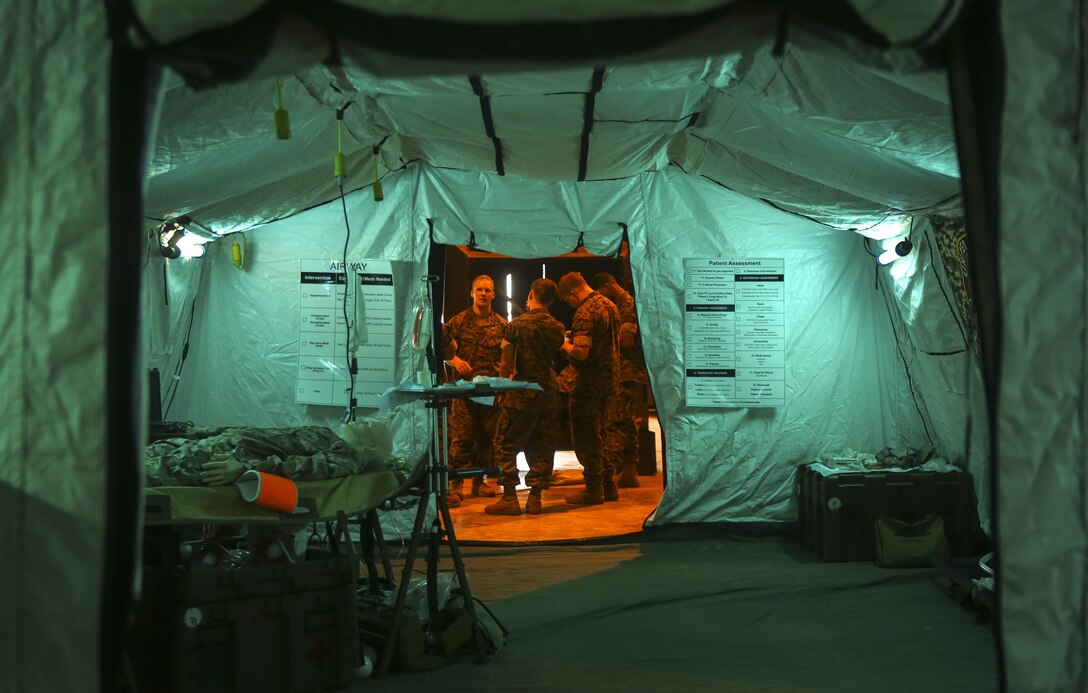 Navy Corpsmen wait to greet the Japanese Ground Self Defense Force at Camp Kinser, Okinawa, Japan, July 20, 2016. Japanese Ground Self Defense Force officers observed how U.S. Sailors would use a mobile operating room so that they can take care of personnel at the sight of injury. (U.S. Marine Corps photo by Lance Cpl. Nelson Duenas/ Released)