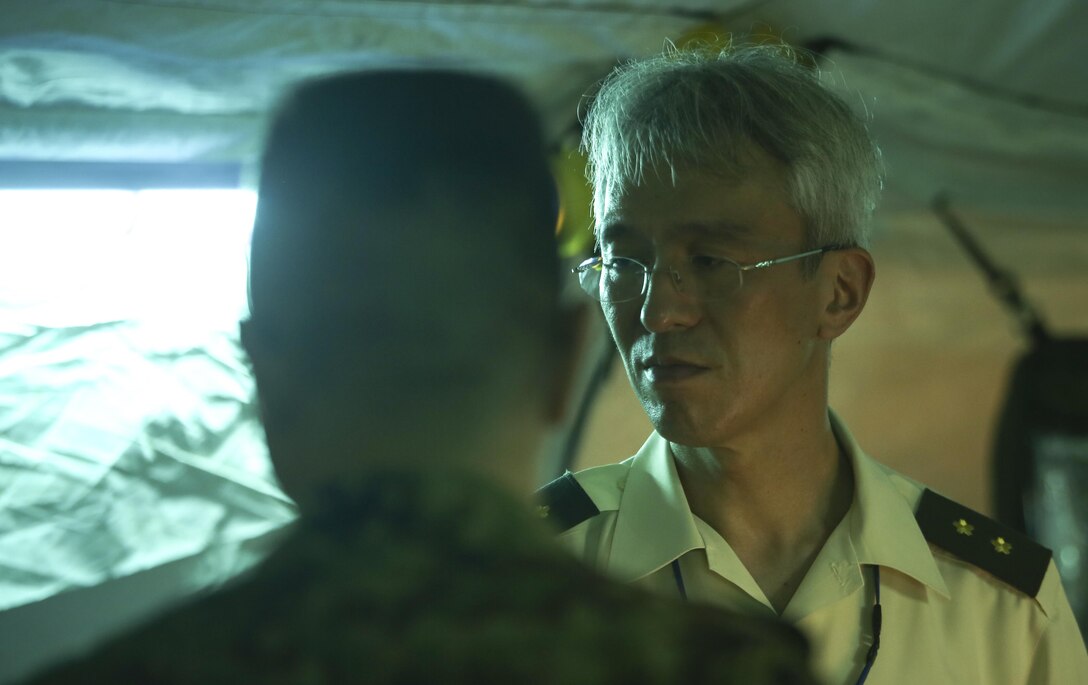 Japan Ground Self-Defense Force Maj. Gen. Satoshi Suzuki, Director of JGSDF Medical department, observed how U.S. Navy Corpsmen would use a mobile operating room at Camp Kinser, Okinawa, Japan, July 20, 2016. The corpsmen began by giving a class on lifesaving skills, followed by an open question session with a group of Navy Corpsmen.  (U.S. Marine Corps photo by Lance Cpl. Nelson Duenas/ Released)