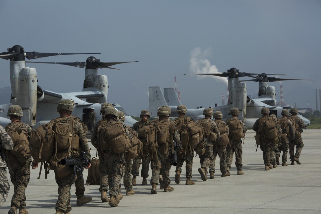 U.S. Marines hike to their designated position to set up security around an air strip July 20, 2016 2016 at Iejima, Okinawa, Japan. Marines immediately set up security, simulated engaging the enemy and set up a combat operations center after getting off an MV-22B Osprey Tiltrotor Aircraft. The Marines were a part of Golf Company, 2nd Marine Division currently attached to 4th Marine Regiment, 3rd Marine Division, III Marine Expeditionary Force through the unit deployment program. (U.S. Marine Corps photo by Lance Cpl. Amaia Unanue/Released)