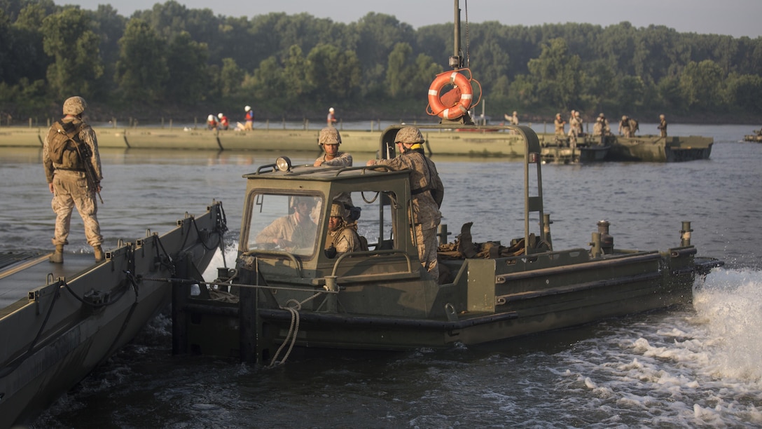 Marines with Bridge Company, 8th Engineer Support Battalion and Bridge Co. Bravo, 6th ESB maneuver an Improved Ribbon Bridge using a Mk3 bridge erection boat during Exercise River Assault on Fort Chaffee, Arkansas, July 19, 2016. The Marines prepped and guided IRBs upstream to link with U.S. Army 814th Multi-Roll Bridge Co.