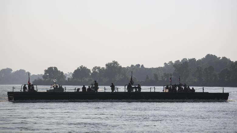 U.S. Army soldiers with 814th Multi-Roll Bridge Company float four Improved Ribbon Bridges to complete the continuous span bridge during Exercise River Assault on Fort Chaffee, July 19, 2016. The Marines spent two weeks operating Mk3 bridge erection boats and practicing connecting all the IRBs in preparation for the final exercise, which was a continuous IRB spanned across the Arkansas River.