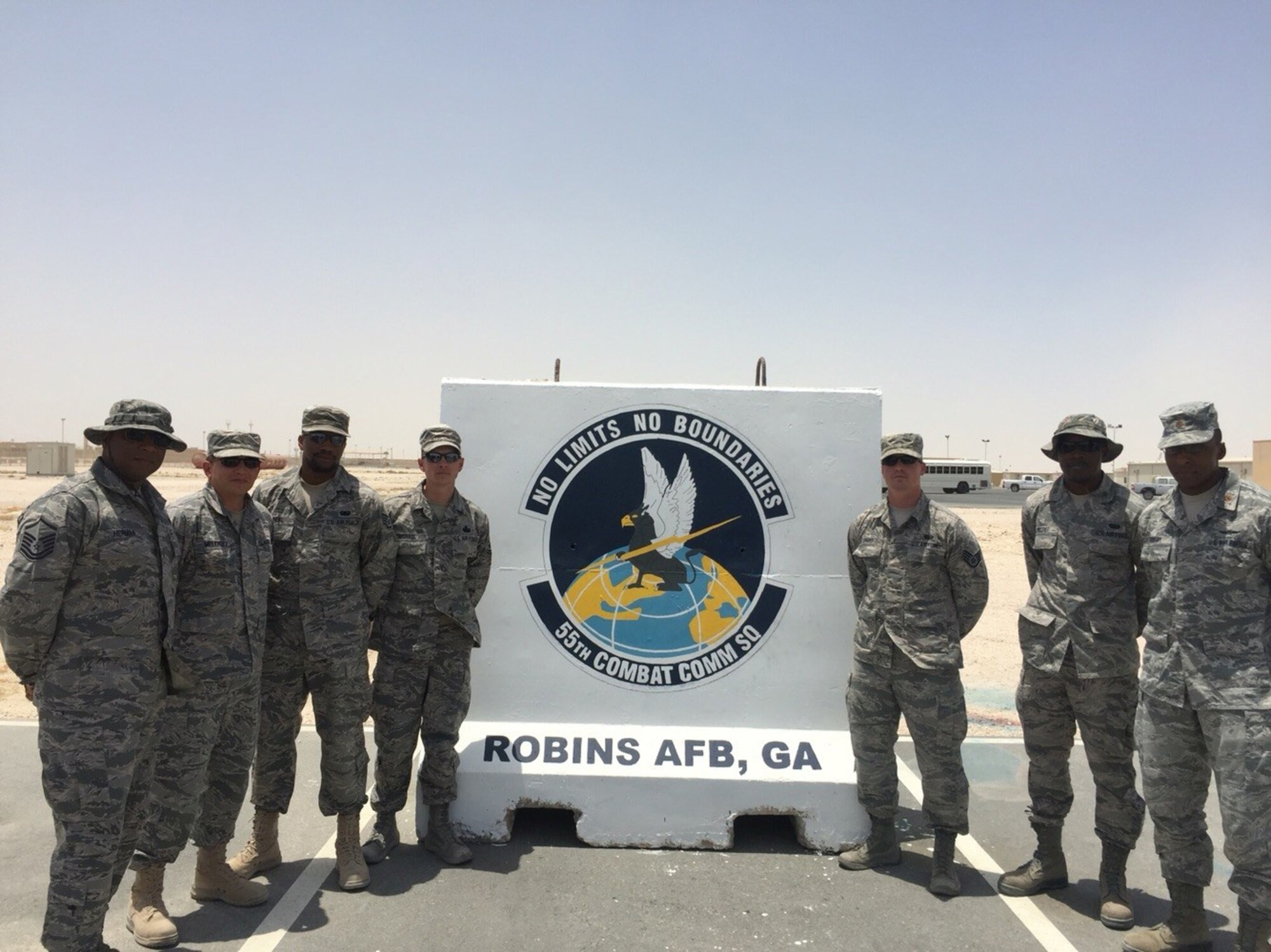 A team of Citizen Airmen recently deployed from the 55th Combat Communications Squadron to a base in the Air Forces Central Command area of responsibility, leaving thier mark not only by the hard work they did, but also by painting thier squadron emblem on one of the base's security barriers. Pictured from left to right, the team consisted of Master Sgt. Nichols Herman, Tech. Sgt. Daniel Melende, Staff Sgt. Jay Oneal, Master Sgt. Shane Michael, Master Sgt. Shane Michael, Staff Sgt. Jeremy Smartis, Senior Airman Blanton McGhee, and Maj. Ricky Hornsby. (U.S. Air Force courtesy photo)
