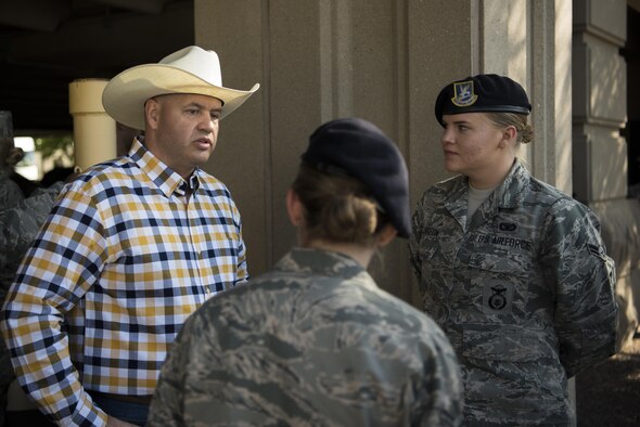 Chief Master Sgt. Jeffery Steagall, 90th Missile Wing command chief, speaks with 90th Missile Security Forces Squadron members, Airman 1st Class Kaylee Morin and Airman 1st Class Christina Sturgeon, before the Cheyenne Frontier Days opening grand parade in Cheyenne, Wyo., July 23, 2016. Leadership from the 90th Missile Wing works closely with the Cheyenne community to foster a strong partnership. (U.S. Air Force photo by Staff Sgt. Christopher Ruano)