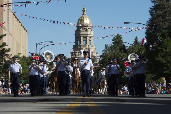 Members of the U.S. Air Force Academy Band play music as they march down the streets of Cheyenne, Wyo., during the 120th Cheyenne Frontier Days opening grand parade, July 23, 2016. Airmen play many roles in making CFD, the biggest event in Cheyenne, a success. (U.S. Air Force photo by Staff Sgt. Christopher Ruano)