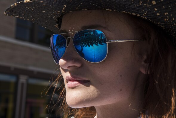 A Cheyenne resident watches 90th Missile Wing Airmen march by in formation in the 120th Cheyenne Frontier Days opening grand parade in Cheyenne, Wyo., July 23, 2016. Hundreds of residents and visitors attended the parade and several service branches participated. (U.S. Air Force photo by Staff Sgt. Christopher Ruano)