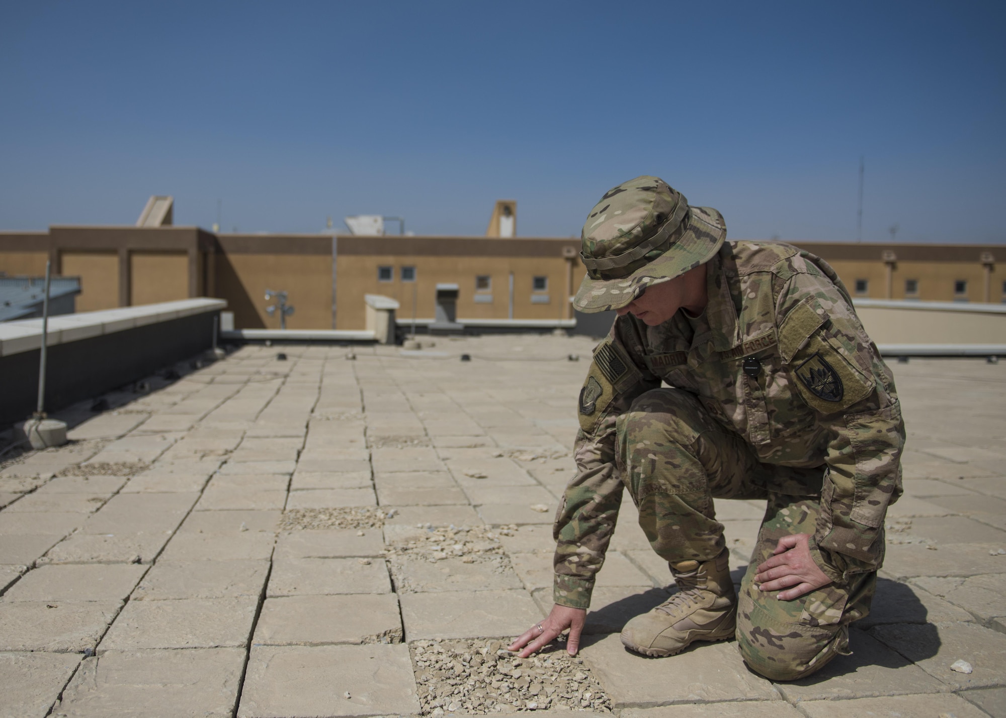 Master Sgt. Jana Madrid, 455th Expeditionary Medical Group, biomedical equipment technician and facility manager, checks roof blast tiles, Bagram Airfield, Afghanistan, July 23, 2016. Blast tiles provide roof hardening and require replacement once deteriorated. As the facility manager of the Craig-Joint Theater Hospital, Madrid ensures all facility maintenance and safety standards are met. (U.S. Air Force photo by Senior Airman Justyn M. Freeman)