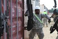 FORT MCCOY,Wisc.-- Spc. Jonathan Bryant, a cargo specialist from Los Angeles with the 211th Inland Cargo Transportation Company, based in Orange County, Calif., prepares to hook a loader to a connex for the Trans Warrior exercise, lasting from July 9 to July 23, 2016. Soldiers of the 211th hone and evaluate their individual and unit collective tasks during Trans Warrior, here (U.S. Army Reserve photo by Spc James C. Blackwell, 206 Broadcast Operations Detachment)

