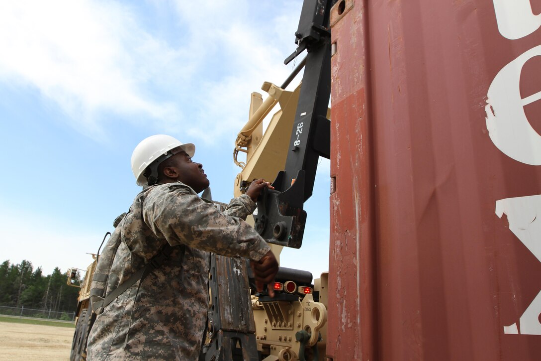 FORT MCCOY, Wisc. -- Spc. Jonathan Bryant, a cargo specialist from Los Angeles with the 211th Inland Cargo Transportation Company, based in Orange County, Calif., hooks a loader to a connex during the Trans Warrior exercise, lasting from July 9 to July 23, 2016. Soldiers of the 211th hone and evaluate their individual and unit collective tasks during Trans Warrior, here (U.S. Army Reserve photo by Spc James C. Blackwell, 206 Broadcast Operations Detachment)