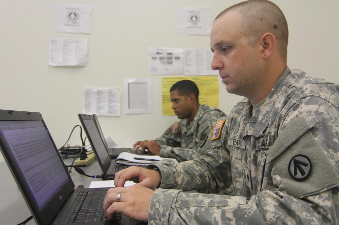 Spc. Warren Beaty, right, and Spc. Alexander Harris, cargo specialists assigned to the 352d Expeditionary Terminal Operations Element based in Sanford, Florida, create cargo load documents during the Army Reserve exercise TRANS WARRIOR 2016. The exercise provides Mission Essential Task List focused training and addresses fundamental Soldier skills. TRANS WARRIOR lasted from July 9 to July 23, 2016. (U.S. Army Reserve photo by 1st Sgt. Timothy Lawn, 205th Press Camp Headquarters)