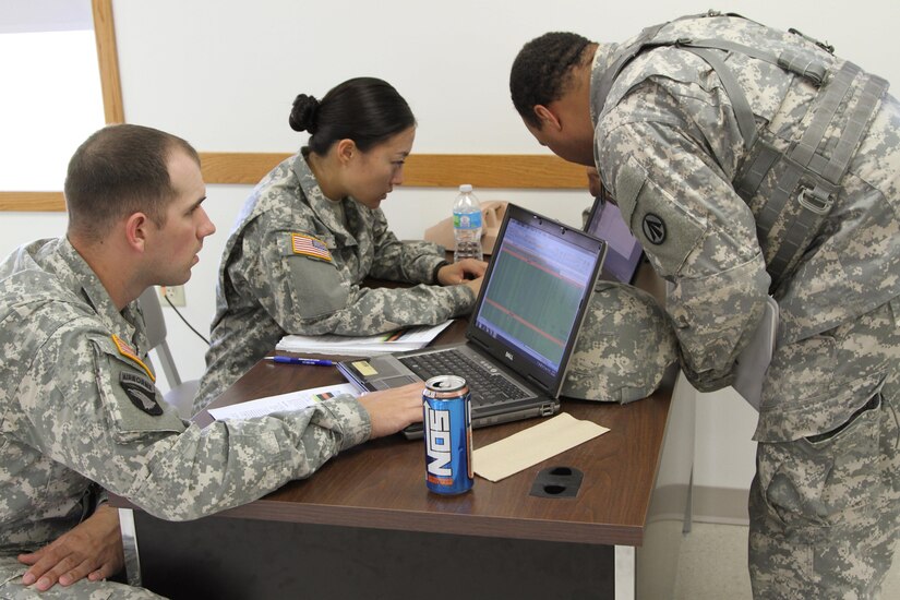 FT. MCCOY, Wisc. – Sgt. 1st Class William Thomas, right, an Observer/Controller/Trainer for the Army Reserve Trans Warrior exercise, reviews Transportation Coordinators’ Automated Information for Movement System II with Sgt. Andrew Davis, left, and Spc. Jiuen Jun, center, members of the 931st Expeditionary Theatre Opening Element, based out of Sherman Oaks, Calif. Trans Warrior was held July 9 through 23, here, providing U.S. Army Reserve transportation Soldiers an opportunity to train realistically on port operations. (U. S. Army Reserve Photo by Sgt. Charlotte Fitzgerald, 345th Public Affairs Detachment)