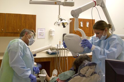 FORT THOMPSON, S.D. --  Spc. Samantha Davis, of the 7239th Medical Support Unit in Chattanooga, Tenn. works with Dr. Velma Dennis to get a dental x-ray of a local patient at the Fort Thompson Indian Health Center.  Davis is one of six U.S. Army Reserve Soldiers from the 1207th U.S. Army Hospital, based at Fort Benning, Ga., that are performing Innovative Readiness Training at the health center.  IRT allows soldiers to sharpen and use their Army skills in real world experiences that benefit local communities. (U.S. Army Reserve photo by Spc. Rachel Skowyra)
