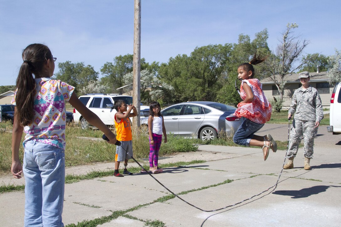 LOWER BRULE RESERVATION– U.S. Army Reserve Soldier Sgt. Jennifer Kunsch, a dental assistant with the 7233rd Medical Support Unit, plays jump rope with local children outside of the Boys and Girls Club in Lower Brule, an Indian Reservation, 60 miles southeast of Pierre, S.D., on July 19, 2016.  Earlier that morning, Sgt. Kunsch discussed oral hygiene with several children at the Boys and Girls Club, as part of the 1207th U.S. Army Hospital’s Innovation Readiness Training event.  IRT allows Soldiers to apply their Army skills in real-world experiences. (U.S. Army Reserve photo by Spc. Rachel Skowyra)
