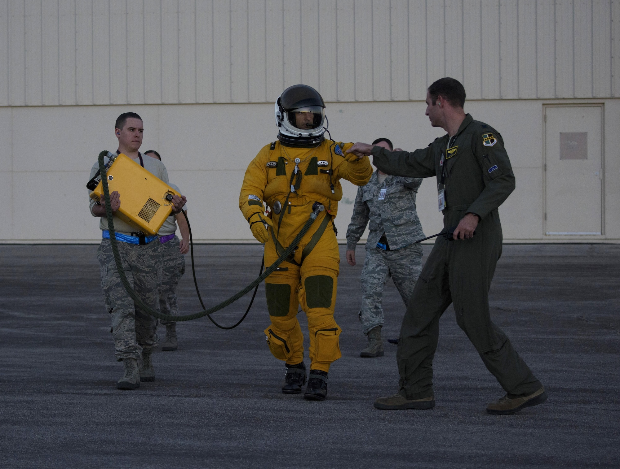 Maj. Carl Maymi, a U-2 pilot with the 1st Reconnaissance Squadron from Beale Air Force Base, Cali., bumps first with a teammate, Capt. Arthur Bull, while walking out to his aircraft Nellis Air Force Base, Nevada July 18, 2016 for exercise Red Flag 16-3.This is the first time in more than 20 years the U-2 has flown in Red Flag while staging out of Nellis Air Force Base. (U.S. Air Force photo/Tech. Sgt. David Salanitri)