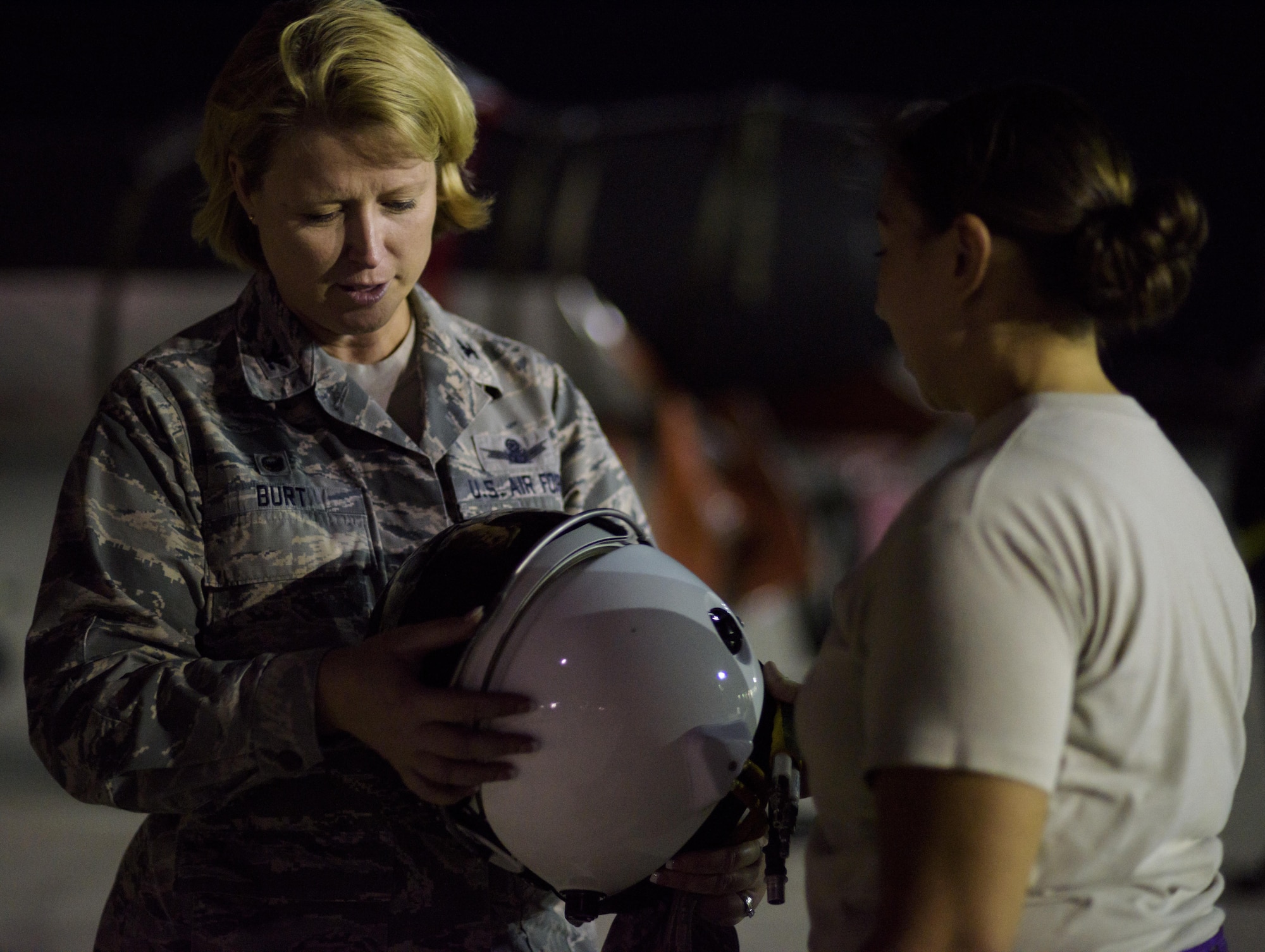 From left, Col. Deanna Burt, the Air Expeditionary Wing commander for exercise Red Flag 16-3 and 50th Space Wing commander, looks over the helmet used minutes ago for a U-2 mission for exercise Red Flag while Staff Sgt. Julie Orellana, 9th Physiology Support Squadron from Beale Air Force Base, Cali., answers questions about the helmet on Nellis Air Force Base, Nevada July 18, 2016.  This is the first time in more than 20 years the U-2 has flown in Red Flag while staging out of Nellis Air Force Base. Red Flag 16-3 incorporates air, space and cyberspace forces. (U.S. Air Force photo/Tech. Sgt. David Salanitri)