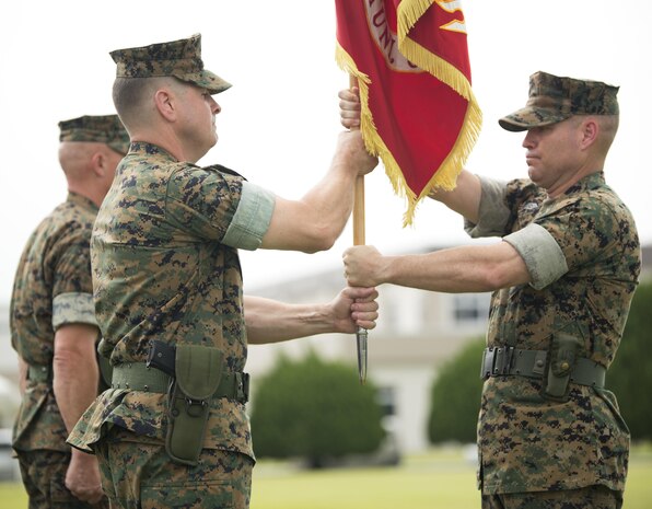 U.S. Marine Corps Col. Robert V. Boucher, outgoing commanding officer of Marine Corps Air Station Iwakuni, Japan, receives the U.S. Marine Corps colors from U.S. Marine Corps Sgt. Maj. Christopher J. Garza, Sergeant major of MCAS Iwakuni, during a change of command ceremony at MCAS Iwakuni, July 22, 2016. Residents, locals and guests gathered aboard Marine Corps Air Station Iwakuni to witness U.S. Marines and sailors welcome Col. Richard Fuerst as their new commanding officer. (U.S. Marine Corps photo by Lance Cpl. Donato Maffin)
