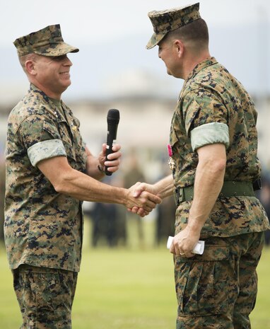 U.S. Marine Corps Col. Robert V. Boucher, outgoing commanding officer of Marine Corps Air Station Iwakuni, Japan, shakes hands with U.S. Marine Corps Maj. Gen. Jaoquin F. Malavet, commanding general of Marine Corps Instillations Pacific, during his change of command ceremony at MCAS Iwakuni, July 22, 2016. Residents, locals and guests gathered aboard MCAS Iwakuni to witness U.S. Marines and sailors welcome Col. Richard Fuerst as their new commanding officer. (U.S. Marine Corps photo by Lance Cpl. Donato Maffin)