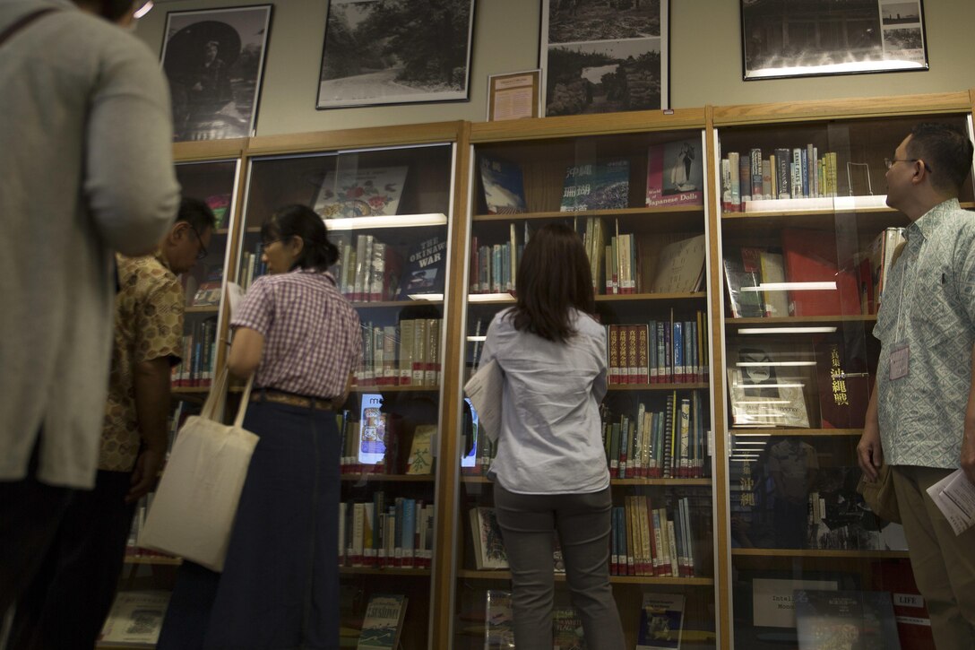 Okinawan librarians tour the Okinawa Collection and Study Guides section at the Camp Foster Library July 12. The visit was part of an exchange program the American and Okinawa librarians. Every American library on Okinawa contains an Okinawa Collection. Once their tour was finished, the librarians ate lunch together laughing and discussing their difference views.