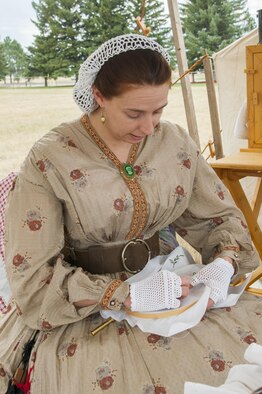 Master Sgt. Amy Leavitt, 90th Logistics Readiness Squadron Property and Cargo Section chief, embroiders a design into cloth July 23, 2016, during Fort D.A. Russell Days, the annual F.E. Warren Air Force Base, Wyo., open house. Leavitt portrayed the American Civil War lifestyle along with other re-enactors. (U.S. Air Force photo by Senior Airman Jason Wiese)