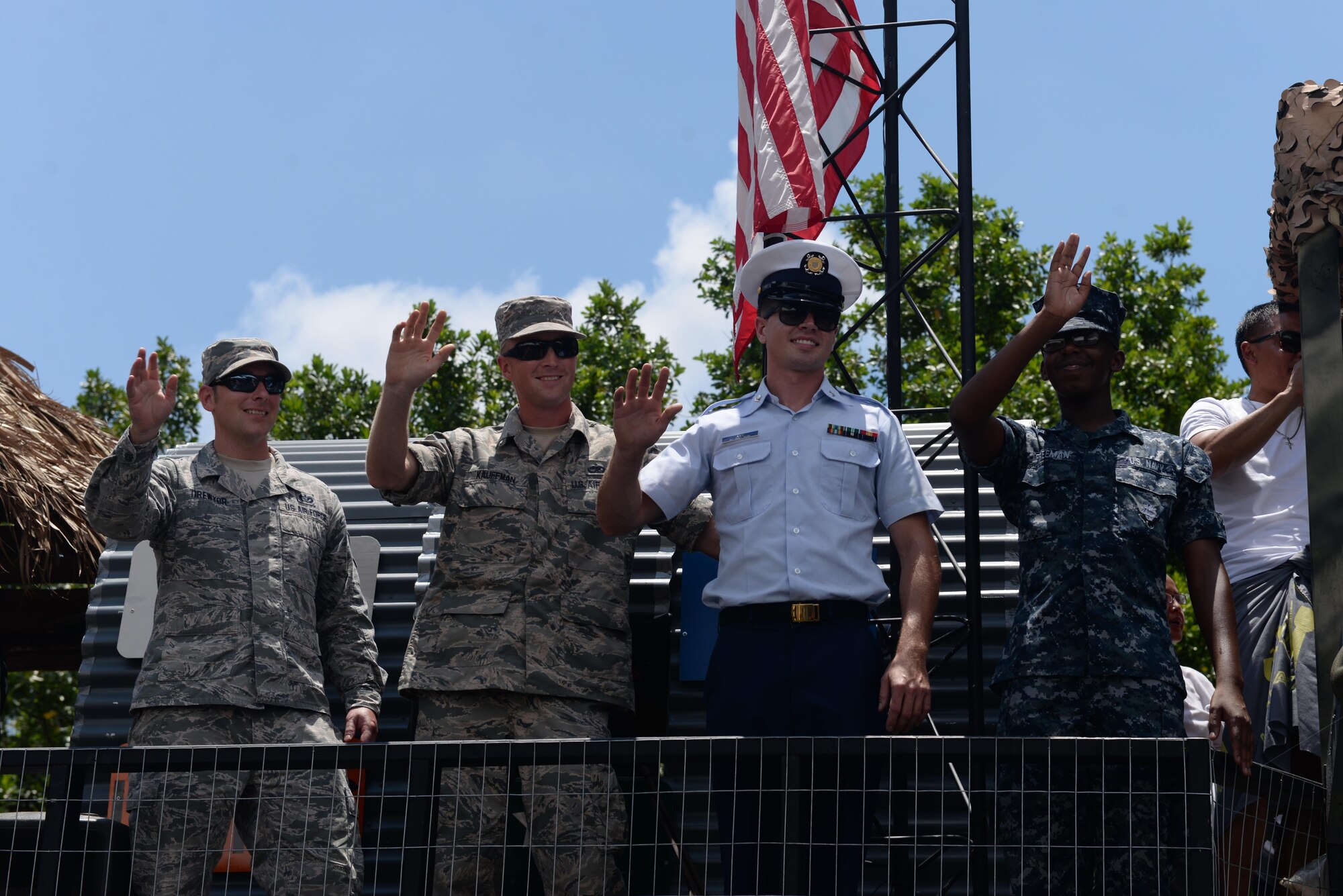 U.S. service members greet bystanders during the 72nd Guam Liberation Day parade July 21, 2016, in Hagåtña, Guam. The parade commemorated 72 years since U.S. armed forces liberated the island from Japanese control during World War II. (U.S. Air Force photo by Airman 1st Class Jacob Skovo/Released)