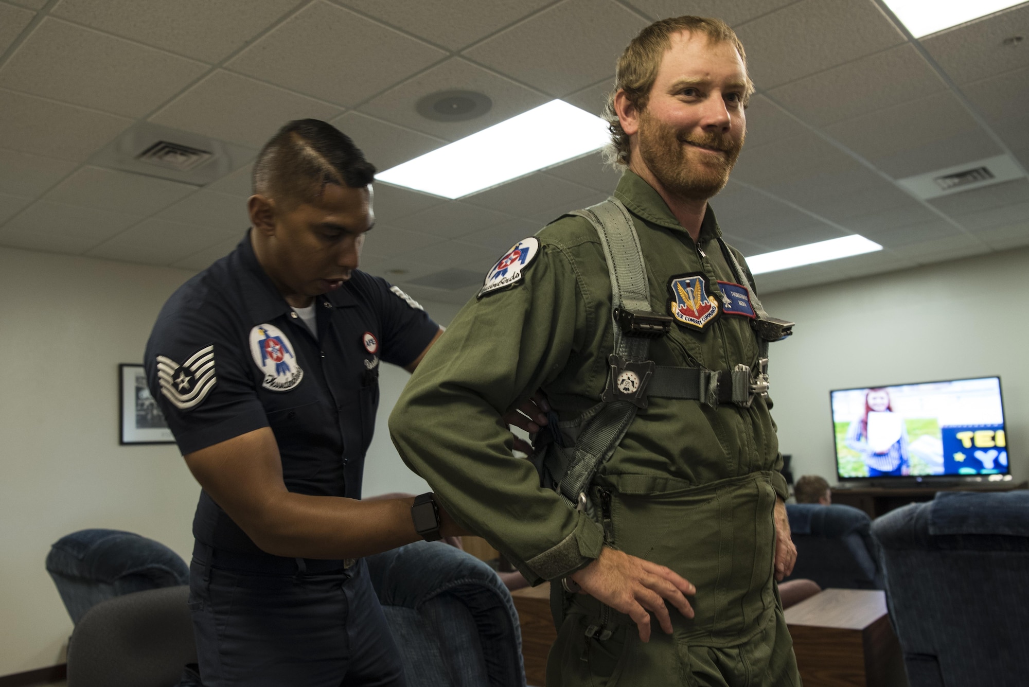 Tech. Sgt. Paul Rosales, U.S. Air Force Thunderbirds aircrew flight equipment technician, fits a flight suit on Chancey Williams before his flight July 24, 2016, on the Wyoming Air National Guard Base, Cheyenne, Wyo. A safety brief is held before the flight to ensure the pilot and occupant are prepared to fly and can handle an in-flight emergency. (U.S. Air Force photo by Staff Sgt. Christopher Ruano)
