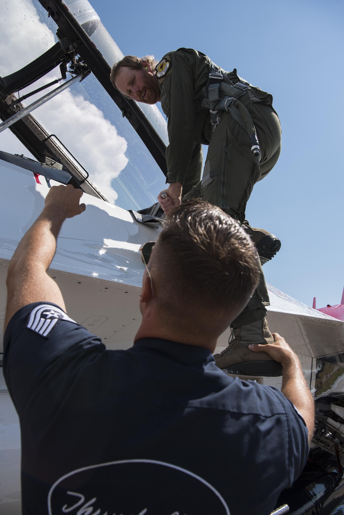 Chancey Williams is assisted into Thunderbird #8 by Tech. Sgt. Conrad Nelson, U.S. Air Force Thunderbirds crew chief, before his celebrity flight July 24, 2016, on the Wyoming Air National Guard Base, Cheyenne, Wyo. Williams is an American country music singer in the Chancey Williams and The Younger Brothers Band. (U.S. Air Force photo by Staff Sgt. Christopher Ruano)
