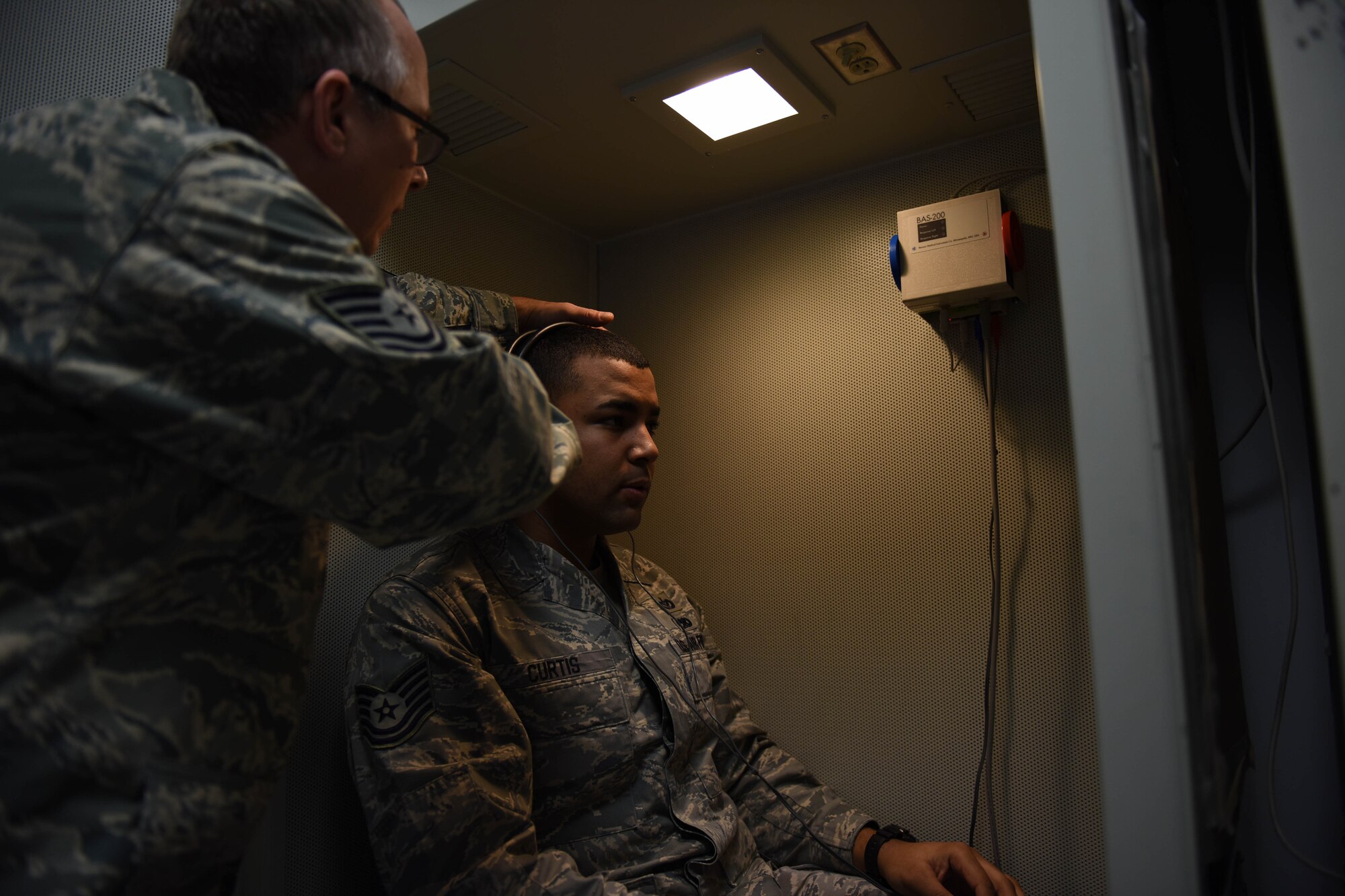 Tech Sgt. Ryan Ward (left), 193rd Special Operations Wing Medical Group public health technician, conducts a hearing exam for an Airman during a recent unit training assembly at Middletown, Pennsylvania. The wing’s flying mission annually requires more than 250 flight physicals and more than 800 occupational health exams be conducted by group personnel. (U.S. Air National Guard photo by Senior Airman Ethan Carl/Released)