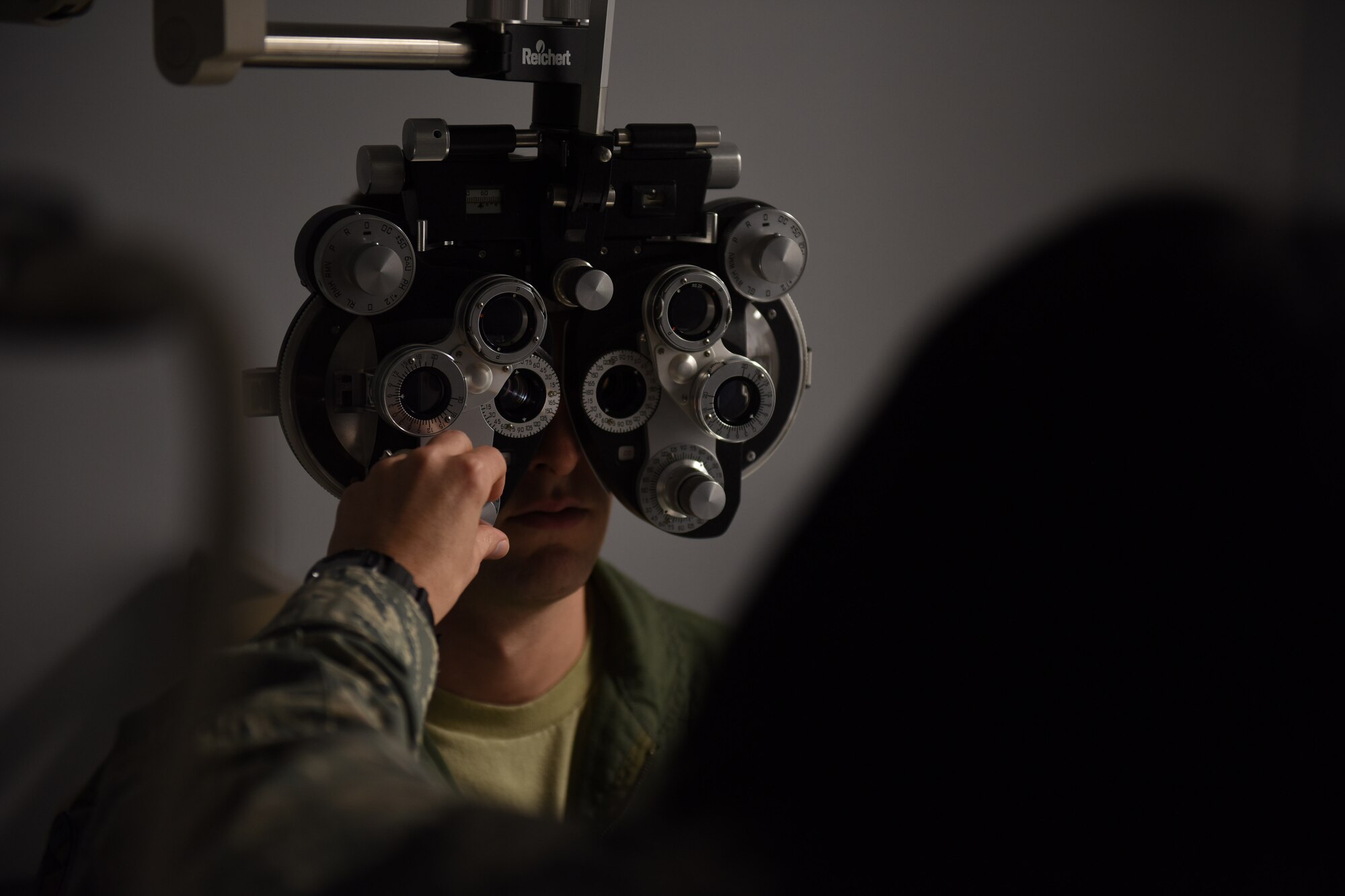 Capt. Amy Brown (right), 193rd Special Operations Wing Medical Group optometrist, conducts an eye exam on a patient during a recent unit training assembly at the wing's Middletown, Pennsylvania, location. The wing’s flying mission annually requires more than 250 flight physicals and more than 800 occupational health exams to be conducted by medical group personnel. (U.S. Air National Guard photo by Senior Airman Ethan Carl/Released)
