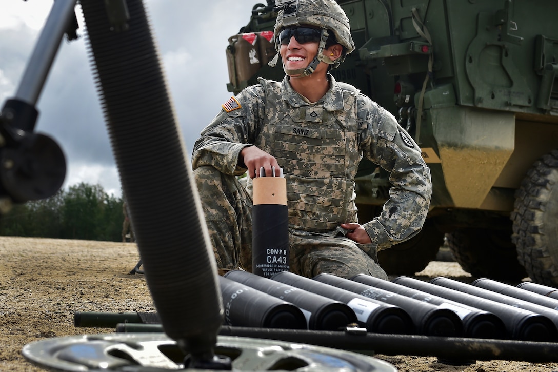 Army Pfc. Pedro Sainz smiles as he waits to hand off ammunition to his firing crew during Arctic Anvil 2016 in the Yukon training area near Fort Wainwright, Alaska, July 23, 2016. Sainz is assigned to the 25th Infantry Division’s 1st Stryker Brigade Combat Team, Alaska. Air Force photo by Justin Connaher