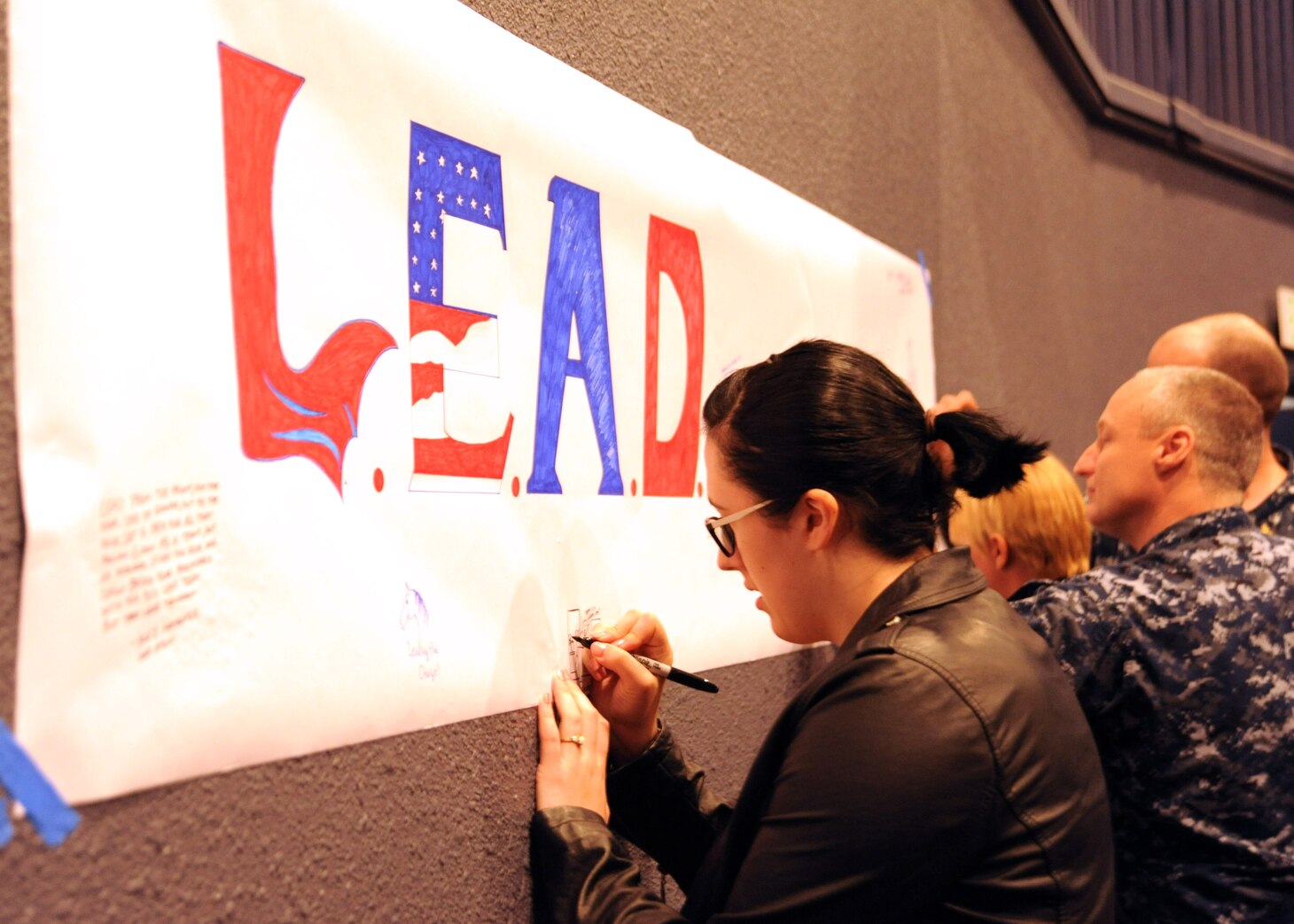 YOKOSUKA, Japan (July 21, 2016)  Cryptologic Technician (Maintenance) 3rd Class Noelle Johnson, assigned to Navy Information Operations Command Yokosuka, draws a picture of what leadership means to her on a poster at 7th Fleet's first Leadership, Equality, and Diversity (LEAD) symposium on Yokosuka Naval Base. The LEAD symposium focused on cultivating leadership and understanding of equality and diversity issues in the Navy. (U.S. Navy photo by Mass Communication Specialist 2nd Class Indra Bosko/Released)