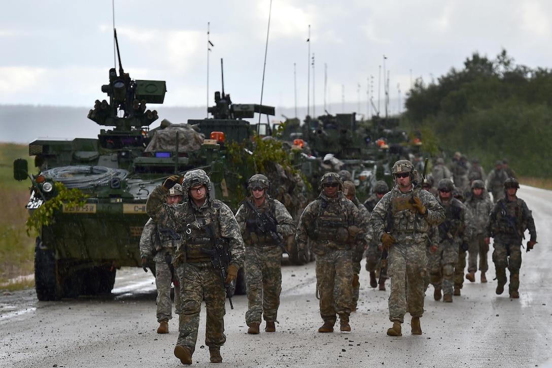 Soldiers walk in the rain before a live-five exercise during Arctic Anvil 2016 in the Yukon training area near Fort Wainwright, Alaska, July 23, 2016. Air Force photo by Justin Connaher