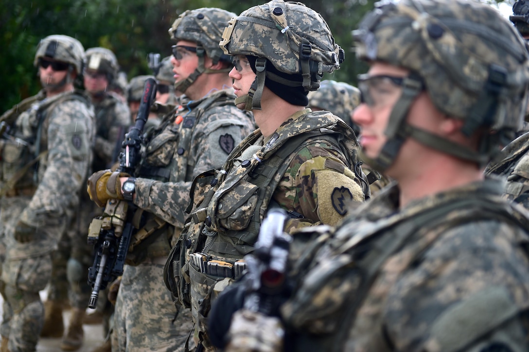 Soldiers listen to a mission brief before participating in a live-five exercise during Arctic Anvil 2016 in the Yukon training area near Fort Wainwright, Alaska, July 23, 2016. The soldiers are assigned to the 25th Infantry Division’s 1st Stryker Brigade Combat Team, Alaska. Arctic Anvil is a multinational exercise that includes active duty soldiers, the Iowa National Guard’s 133rd Infantry Regiment and the 1st Battalion, Princess Patricia’s Canadian Light Infantry. Air Force photo by Justin Connaher