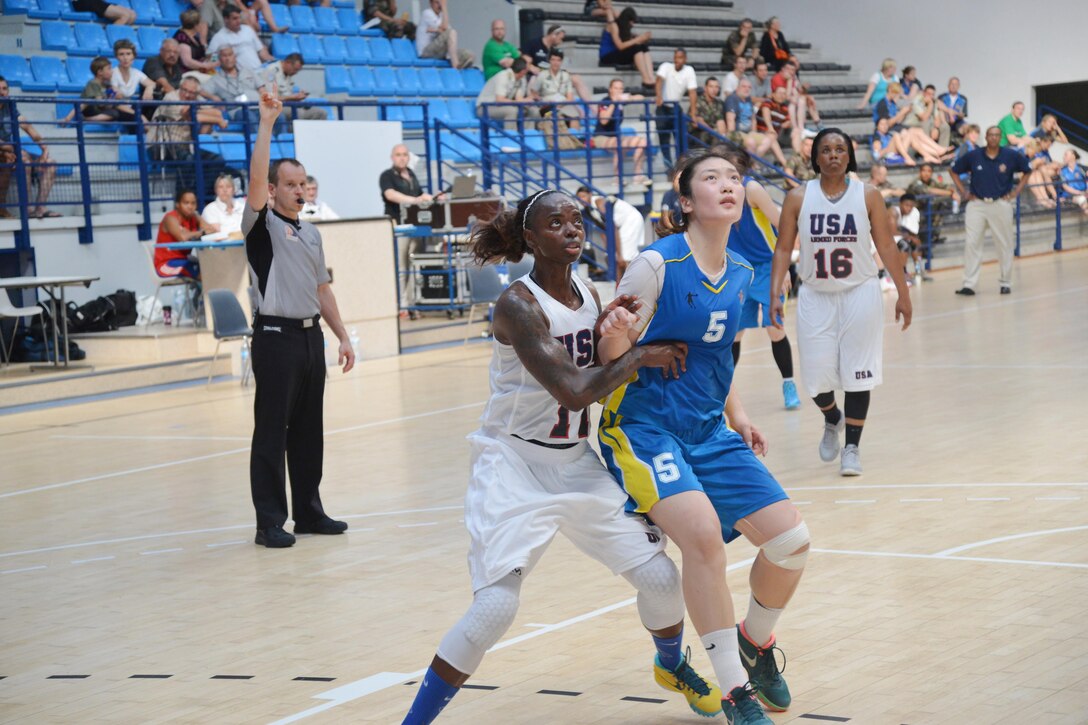 Army Sgt. Kimberly Smith (left) fights for the rebound of the matchup between USA during the 1st CISM World Women's Military Basketball Championship held in Angers, France from
28 June to 5 July 2015.  In this match, China defeated the U.S. in a close game 79-74.  China would finish in second place overall with the U.S. capturing the bronze medal.  
