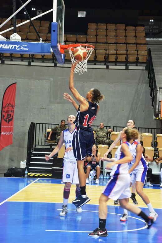 Army Spc. Danielle Salley drives the lane for the layup against French defenders during the bronze medal match of the 1st CISM World Women's Military Basketball Championship held in Angers, France from 28 June to 5 July 2015.  USA defeated France 78-41 to take the bronze.    
