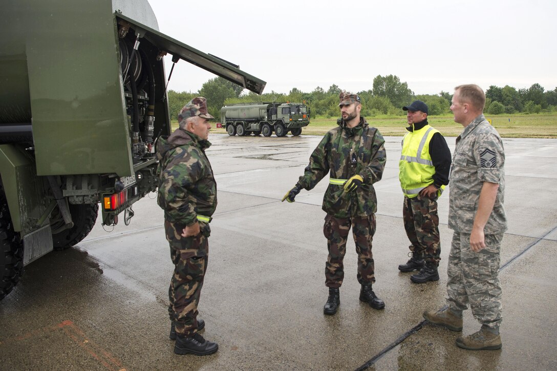 U.S. Air Force Senior Master Sgt. Joseph Wheeler, right, discusses the fueling process with Hungarian air forces refueling specialists after several U.S. F-16 Fighting Falcon aircraft had just landed at Papa Air Base, Hungary, July 16, 2016. Wheeler is a maintenance noncommissioned officer-in-charge assigned to the Colorado Air National Guard’s 140th Wing. Air National Guard photo by Senior Master Sgt. John Rohrer
