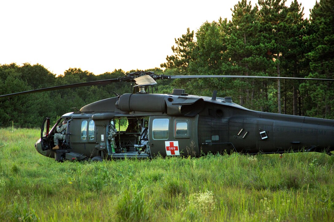 Soldiers prepare a UH-60 Black Hawk helicopter to be used for MEDEVAC training during Warrior Exercise 86-16-03 at Fort McCoy, Wis., July 14, 2016. Army photo by Sgt. Robert Farrell